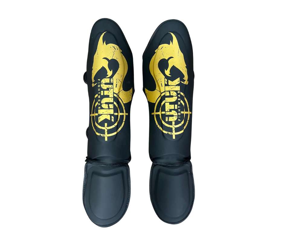 Espinilleras muay thai Utuk hunter negro oro